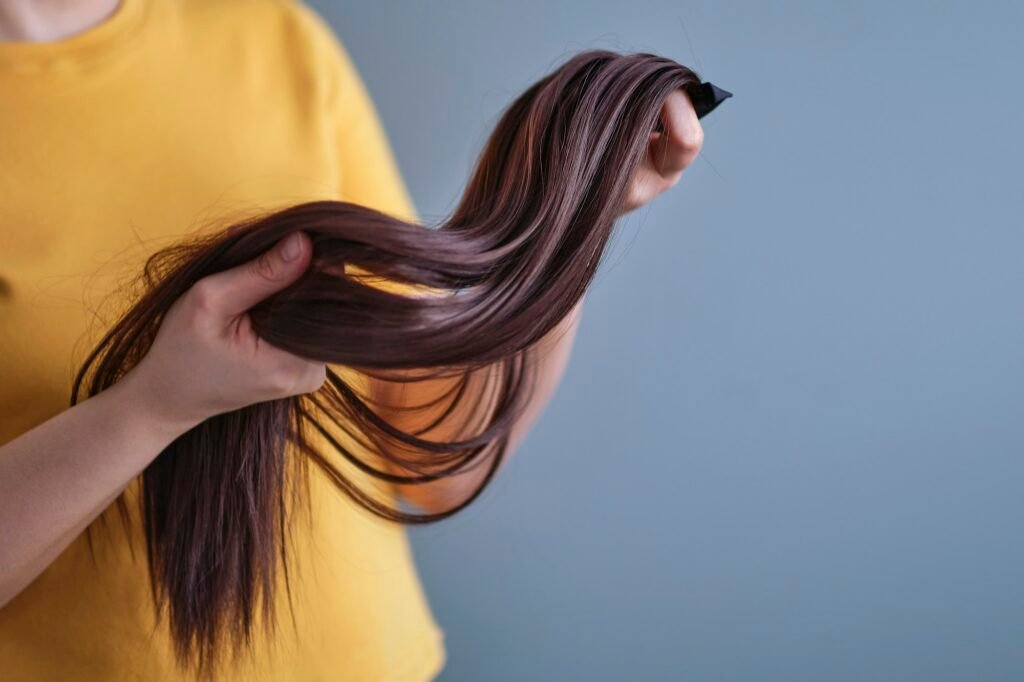 woman holds a bright wig in her hands. Womens beauty concept. Closeup female customer selecting